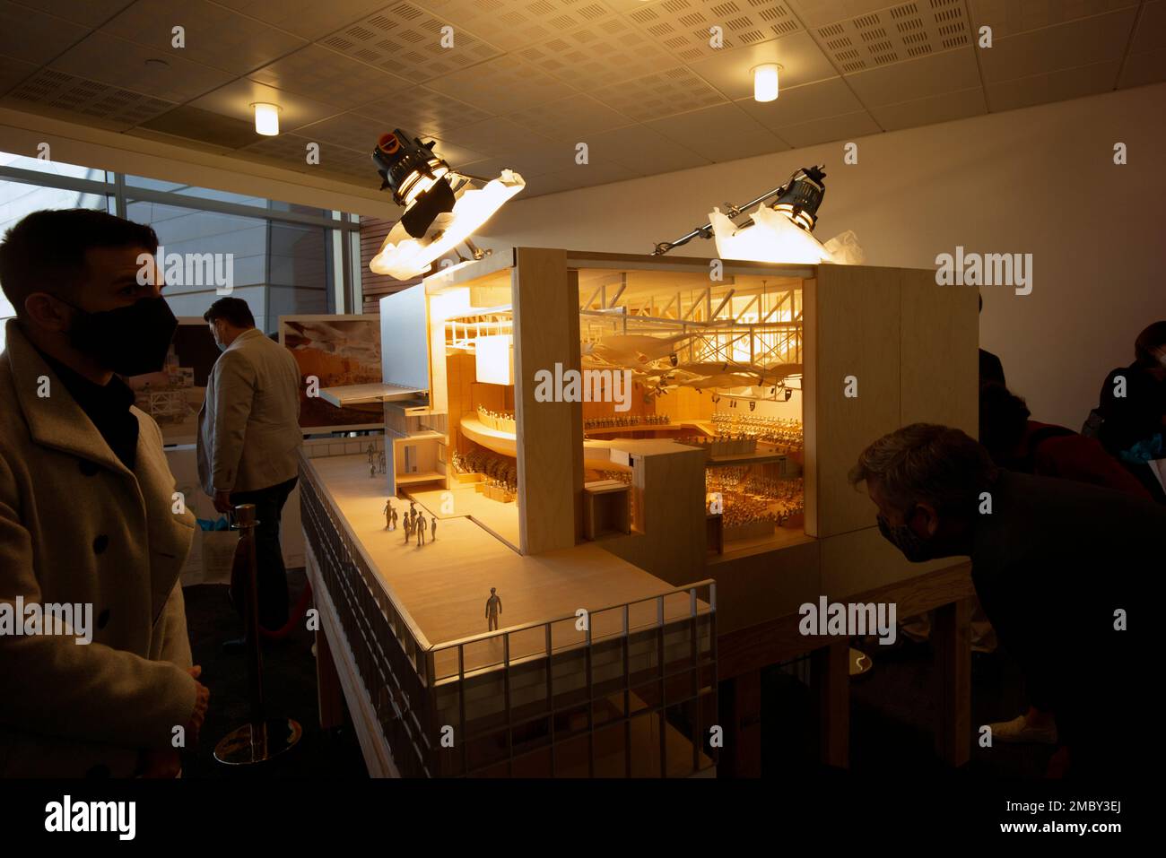 Guests and media check out an architectural model during the unveiling
