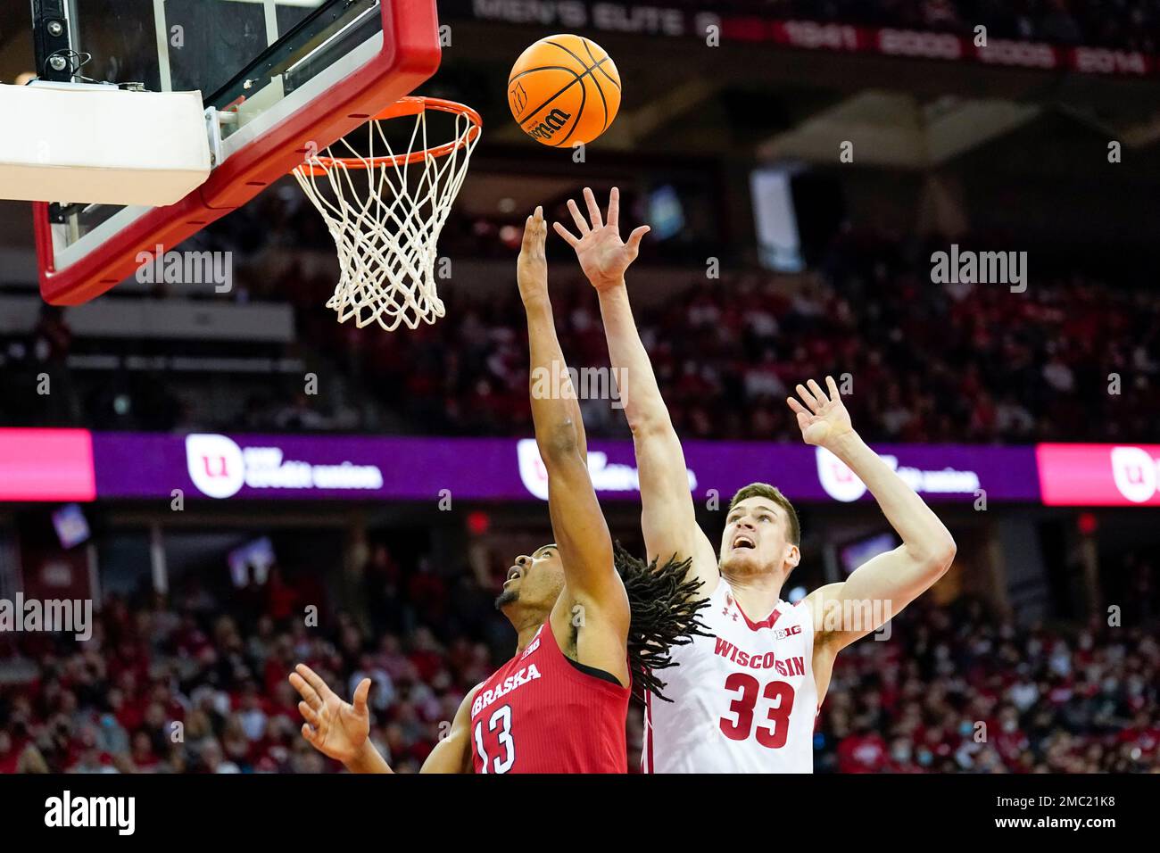 Nebraska's Derrick Walker (13) and Wisconsin's Chris Vogt (33) during