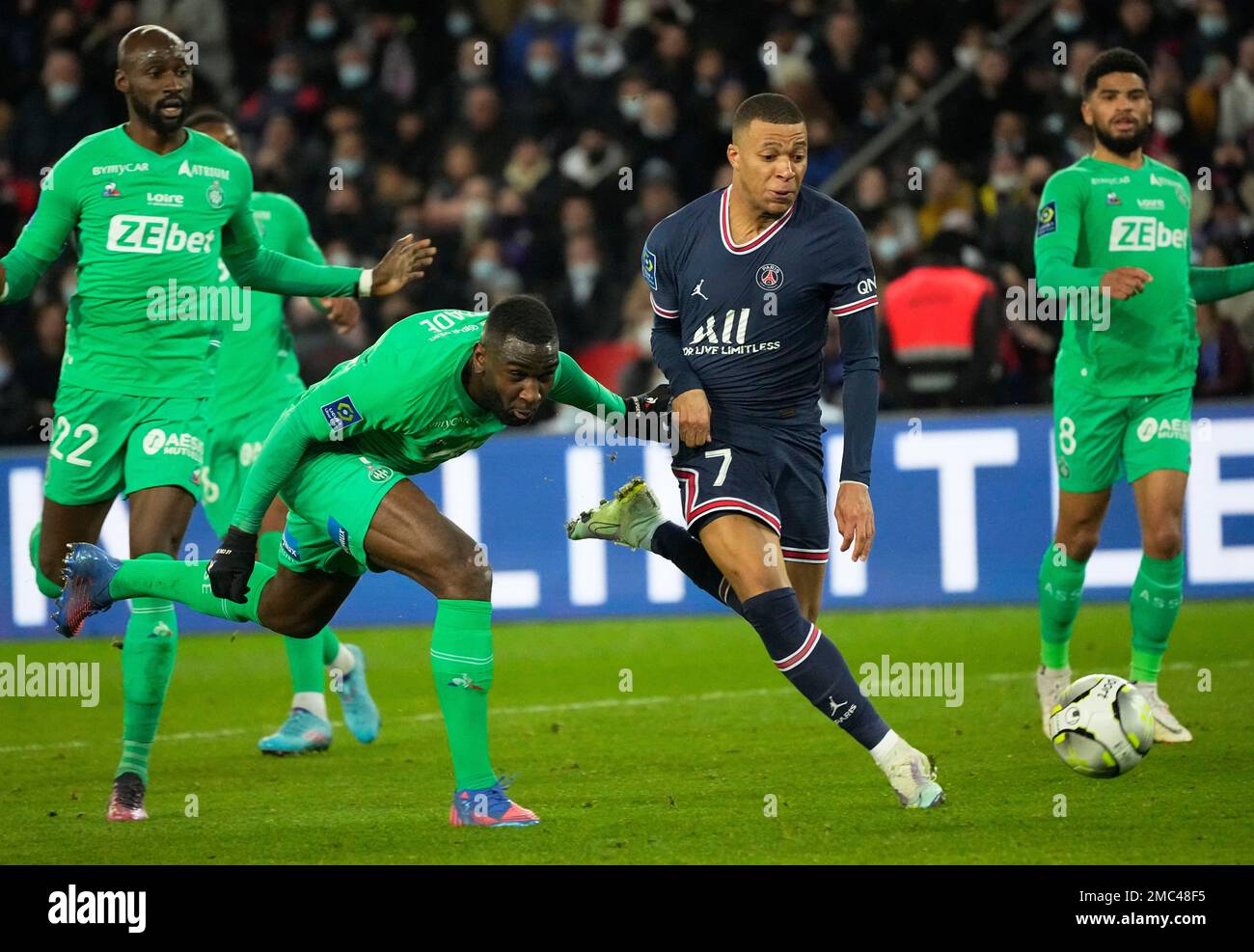 Saint-Etienne's Mickael Nade, left, and PSG's Kylian Mbappe challenge for the ball during the French League One soccer match between Paris Saint Germain and Saint-Etienne at the Parc des Princes stadium in Paris, Saturday, Feb. 26, 2022. (AP Photo/Michel Euler) Stockfoto