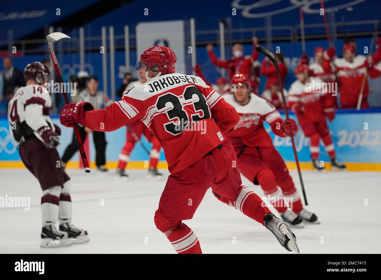 Denmark's Julian Jakobsen (33) celebrates after scoring his team's second goal during a men's qualification round hockey game against Latvia at the 2022 Winter Olympics, Tuesday, Feb. 15, 2022, in Beijing. (AP Photo/Petr David Josek) Stockfoto