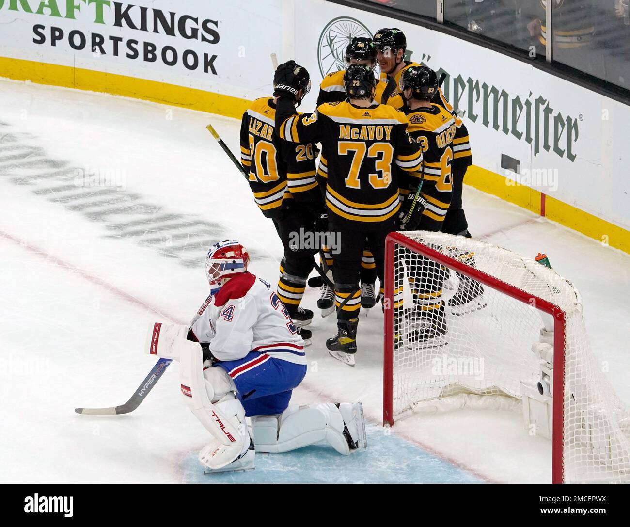 Montreal Canadiens goaltender Jake Allen (34) reacts as Boston Bruins players celebrate with Brad Marchand (63) after he scored during the first period of an NHL hockey game, Wednesday, Jan. 12, 2022, in Boston. (AP Photo/Mary Schwalm) Stockfoto