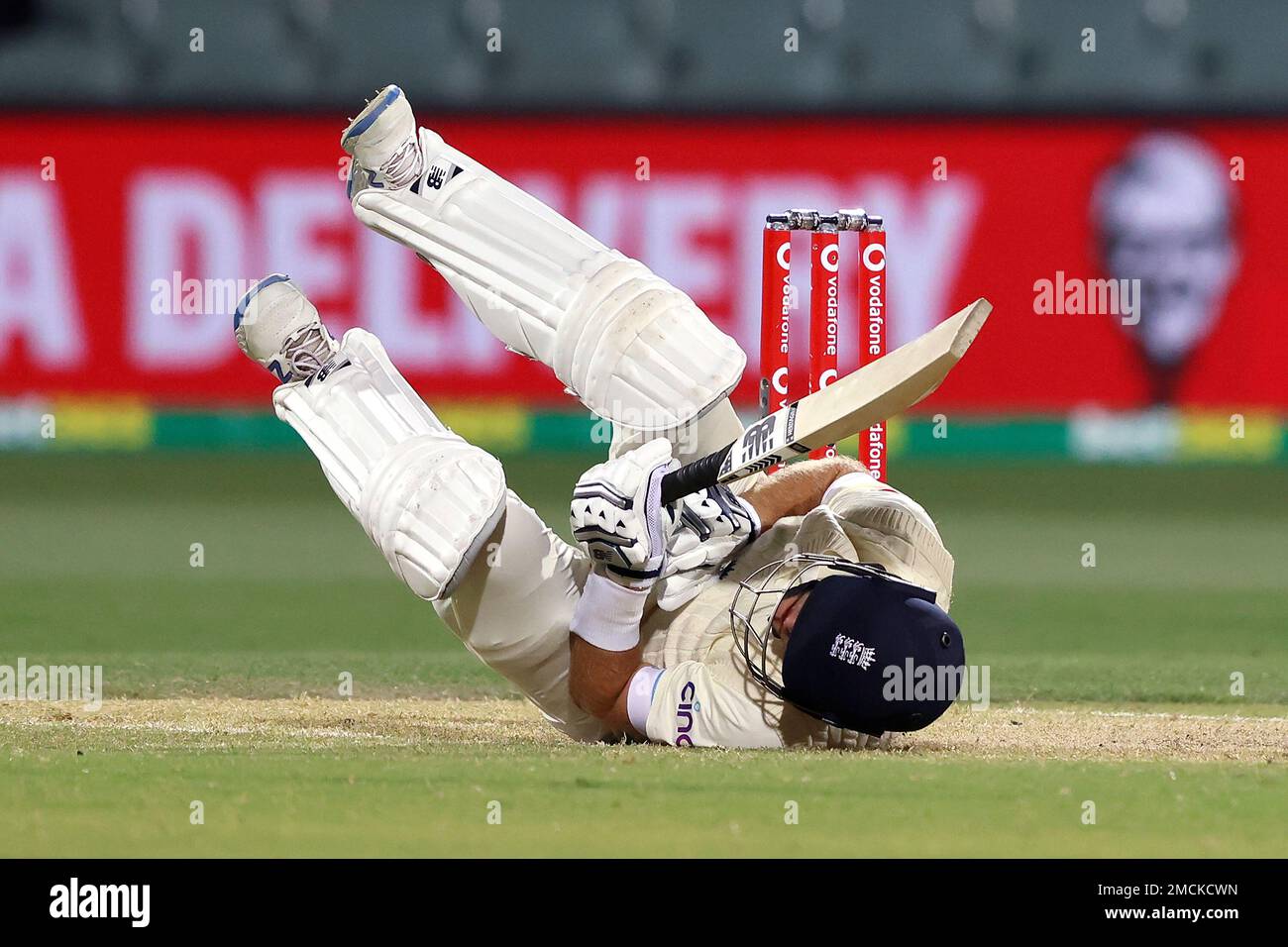 England's Joe Root falls to the ground after he is struck by a delivery from Australia's Mitchell Starc during the fourth day of their Ashes cricket test match in Adelaide, Australia, Sunday, Dec. 19, 2021. (AP Photo/James Elsby) Stockfoto