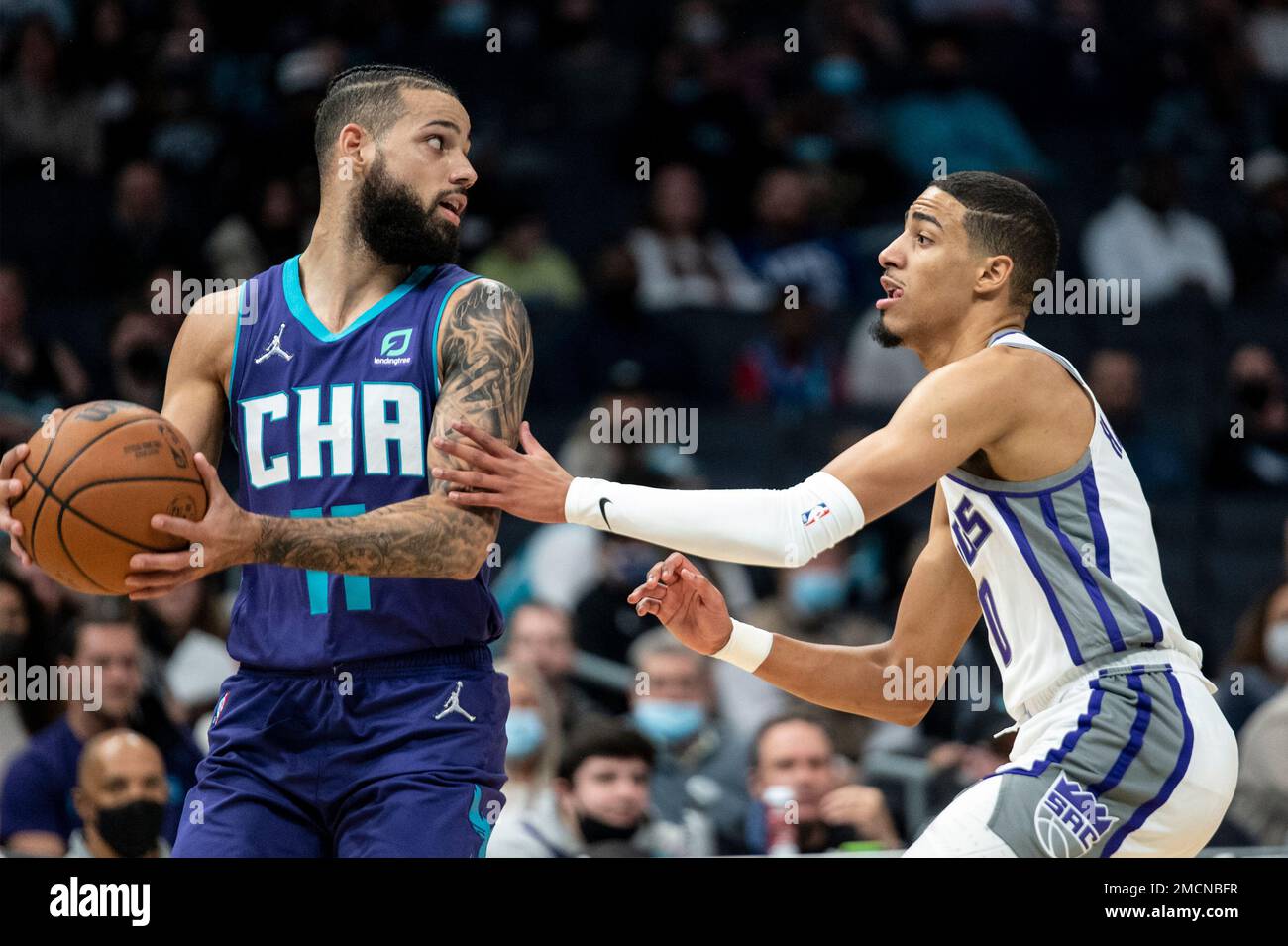 Charlotte forward Cody Martin (11) is defended by Sacramento