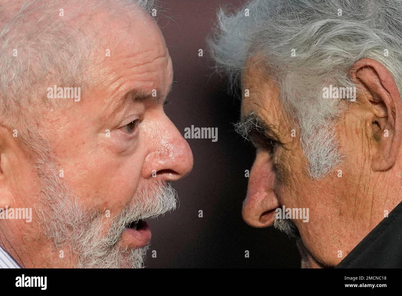 Former Brazilian President Luiz Inacio Lula da Silva, left, talks with Jose "Pepe" Mujica, Uruguay's former President, as they attend an event celebrating the 38th anniversary of democracy's return to the country in Buenos Aires, Argentina, Friday, Dec. 10, 2021. (AP Photo/Natacha Pisarenko) Stockfoto