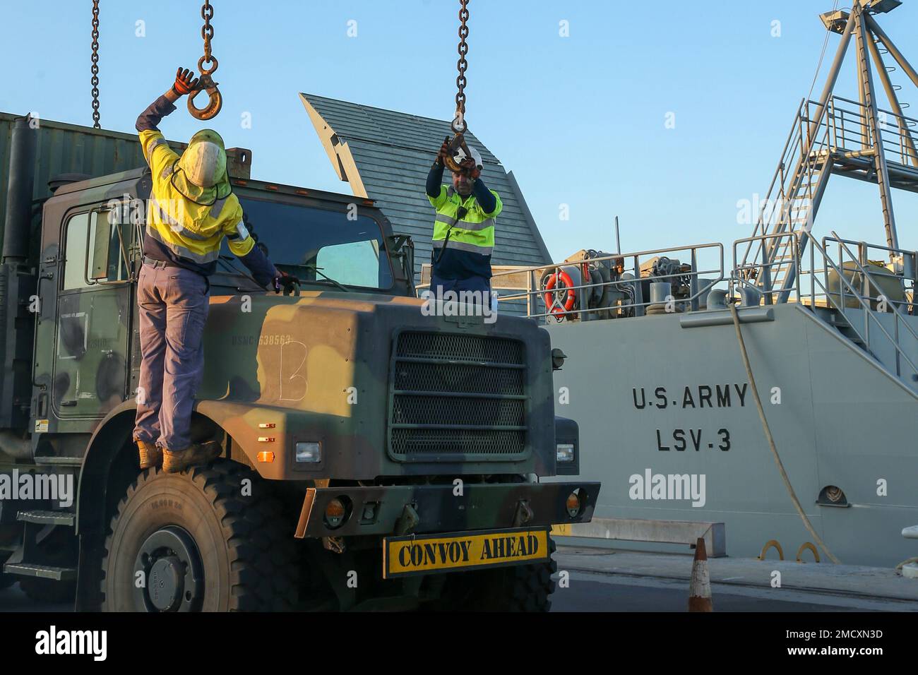 Australische zivile Auftragnehmer bereiten sich darauf vor, Ketten auf ein Medium Tactical Vehicle Replacement von Marine Rotational Force- Darwin 22 zu verriegeln, bevor sie auf das US Army Logistics Support Vessel-3 (LSV-3) „Gen. Brenton B. Somervell während der Übung Koolendong 22, im Darwin Port, NT, Australien, Juli 12, 2022. LSV-3 unterstützte die Übung Koolendong 22 durch den Transport von Ausrüstung und Ausrüstung von Darwin, NT, nach Westaustralien. (USA Marine Corps Fotos von CPL. Kayla D. Treviño) Stockfoto