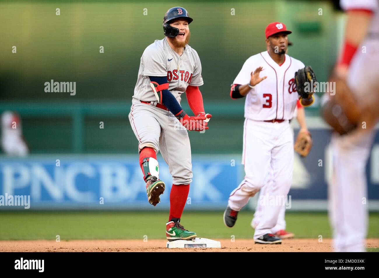 Boston Red Sox's Alex Verdugo reacts at second after he hit a double that scored two runs during the seventh inning of a baseball game against the Washington Nationals, Sunday, Oct. 3, 2021, in Washington. Nationals shortstop Alcides Escobar (3) is at right. The Red Sox won 7-5. (AP Photo/Nick Wass) Stockfoto
