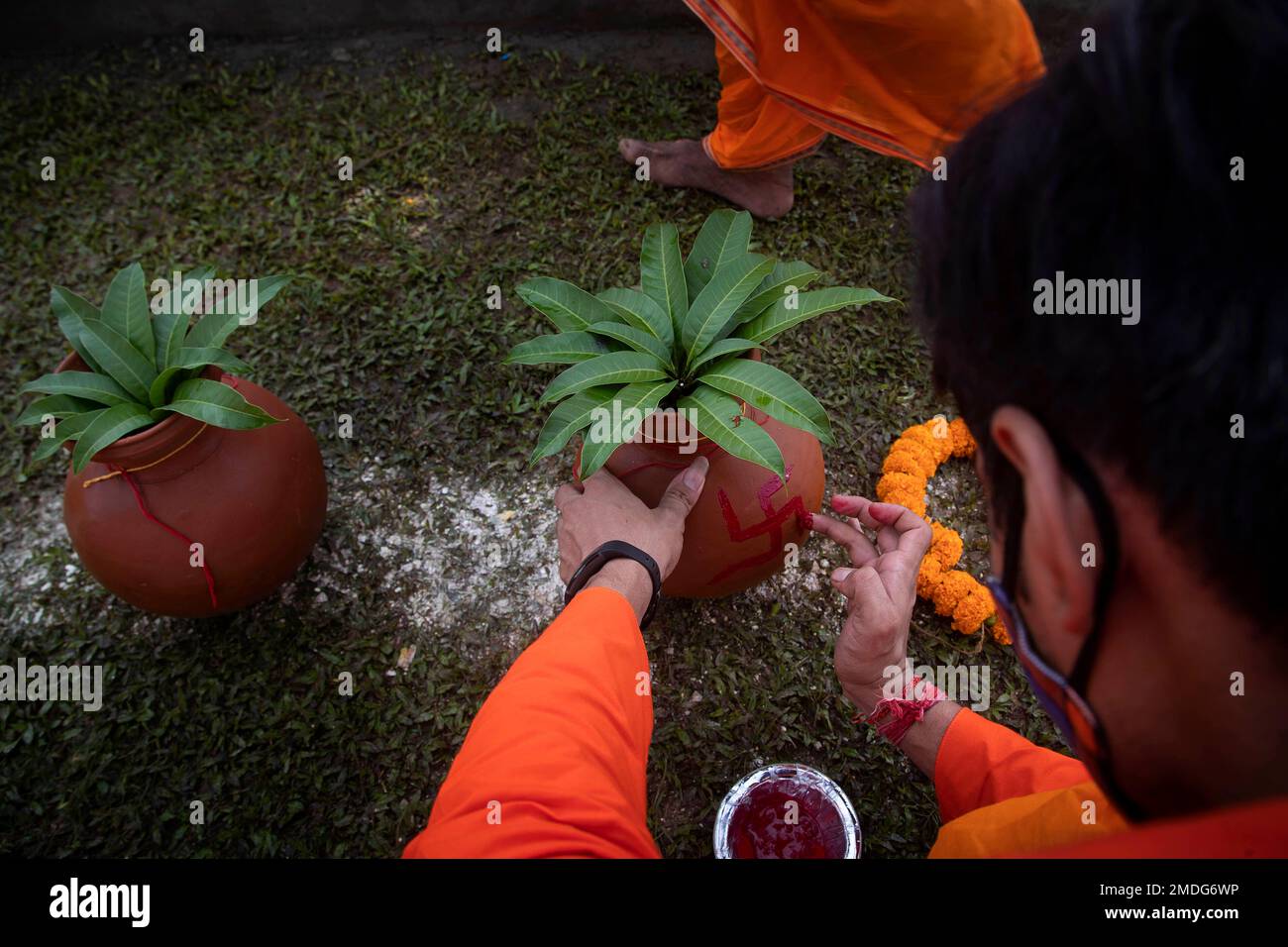 A priest applies vermilion paste as he prepares to perform rituals at ...