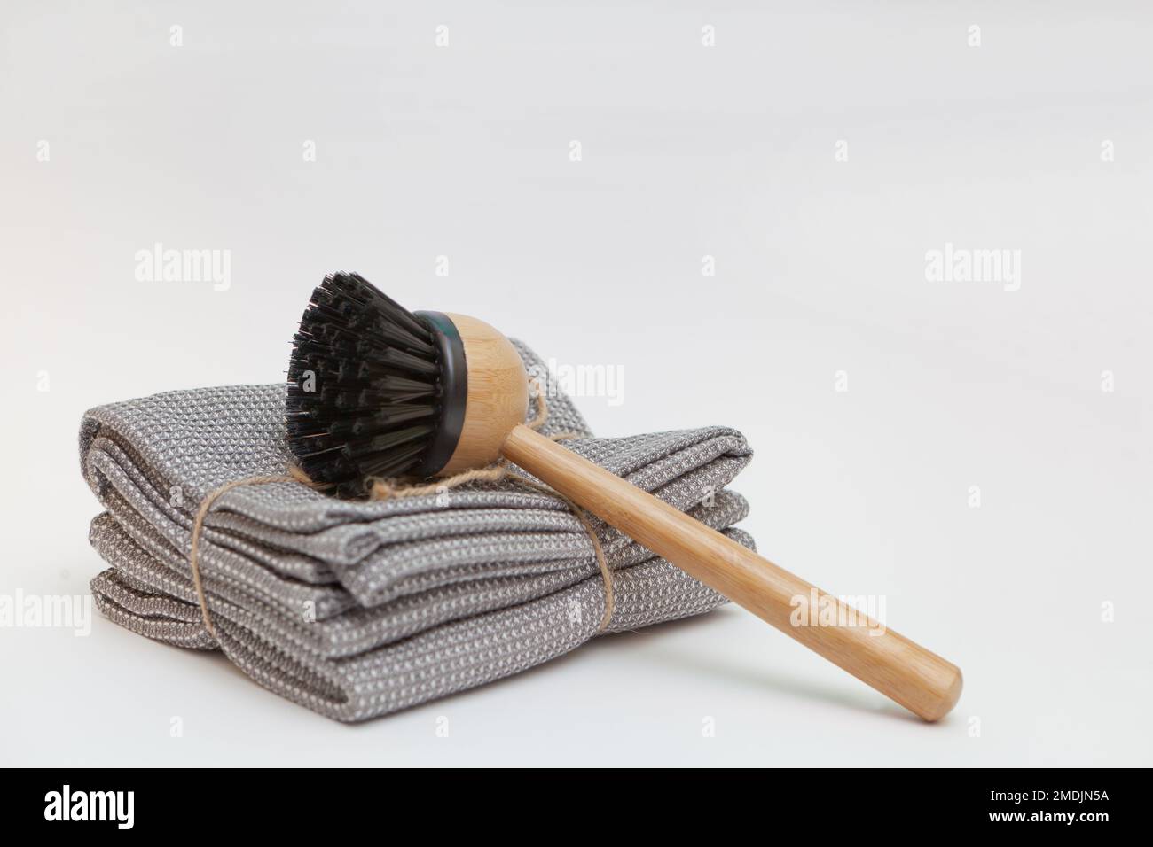 Geschirrspülbürste und graue Handtücher. Konzept für einen nachhaltigen Lebensstil ohne Verschwendung. Sauber ohne Abfall. Keine Kunststoffgegenstände. Stockfoto