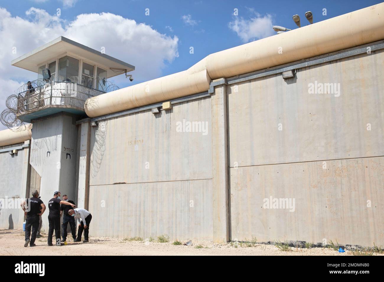 Police officers and prison guards inspect the scene of a prison escape ...