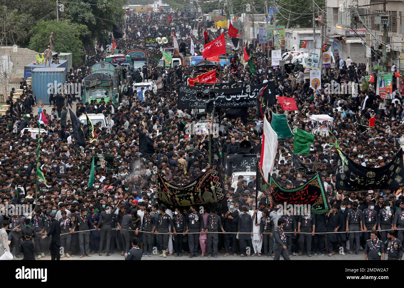 Shiite Muslims attend a procession to mark Ashoura, in Karachi ...
