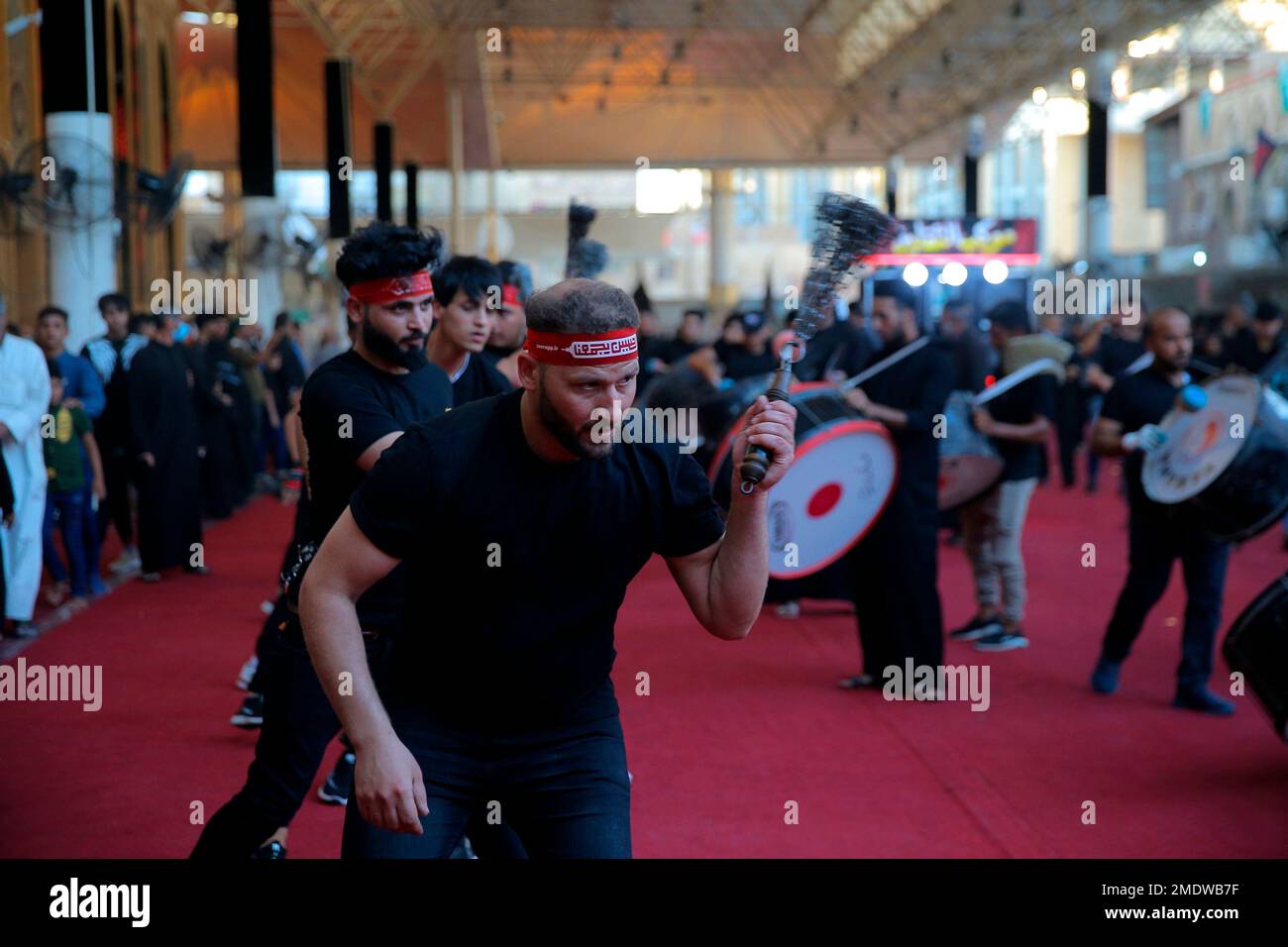 Shiite faithful pilgrims do their ritual during a Muharram procession ...