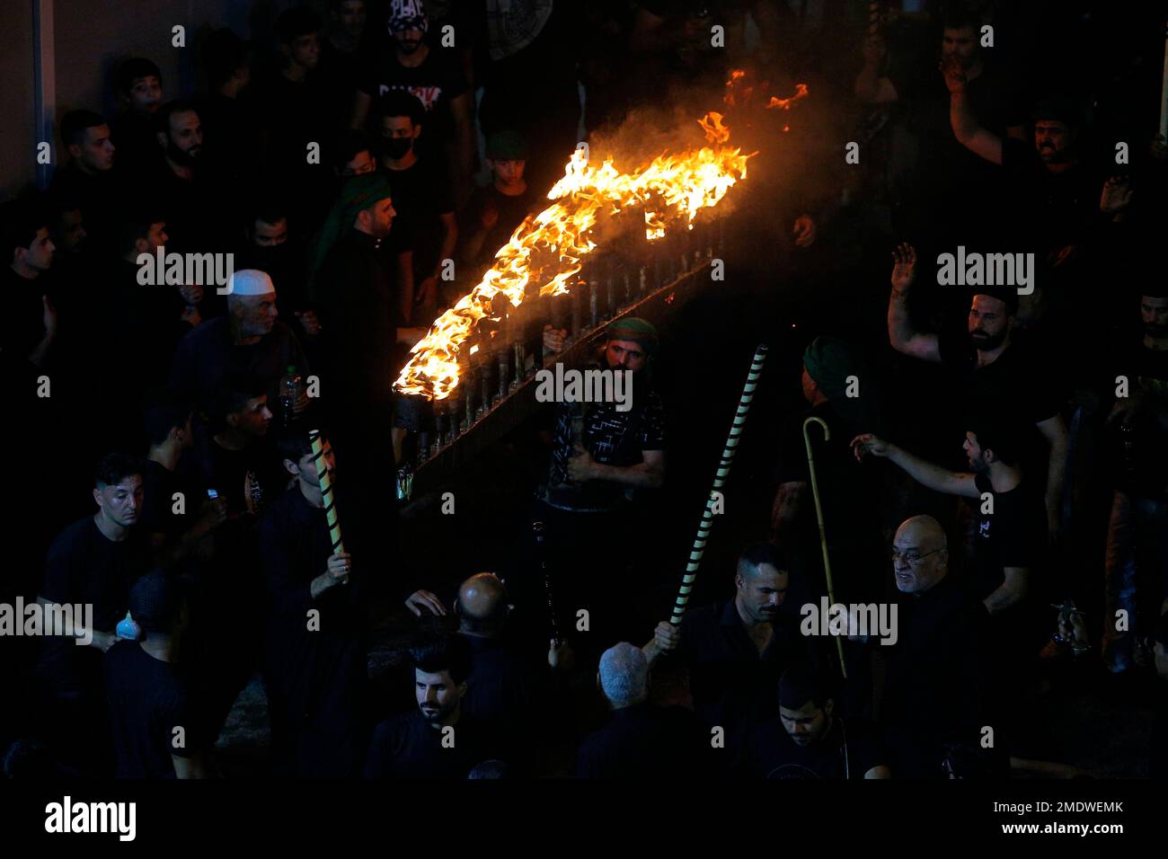 Shiite faithful pilgrims do their ritual during a Muharram procession ...