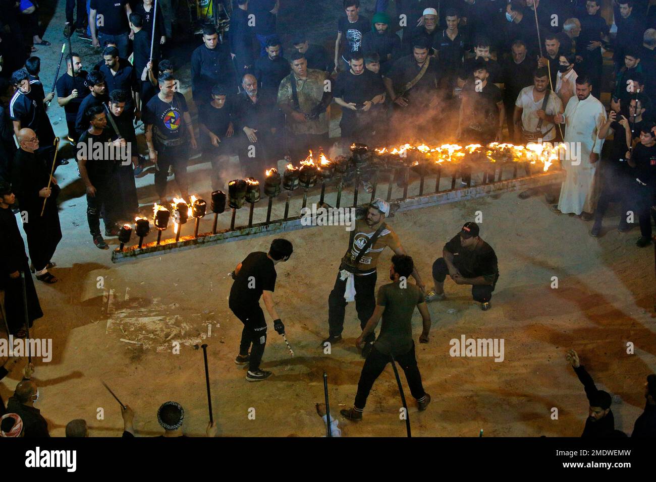 Shiite faithful pilgrims do their ritual during a Muharram procession ...
