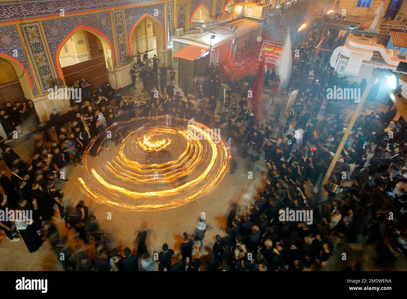 Shiite faithful pilgrims do their ritual during a Muharram procession ...