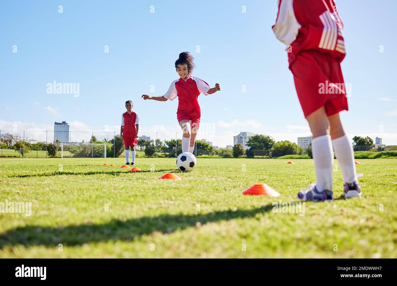 Fußball, Training oder Laufen und eine Mannschaft, die auf einem Trainingsfeld gemeinsam mit einem Ball spielt. Fitness, Fußball und Gras mit Sportkindern Stockfoto