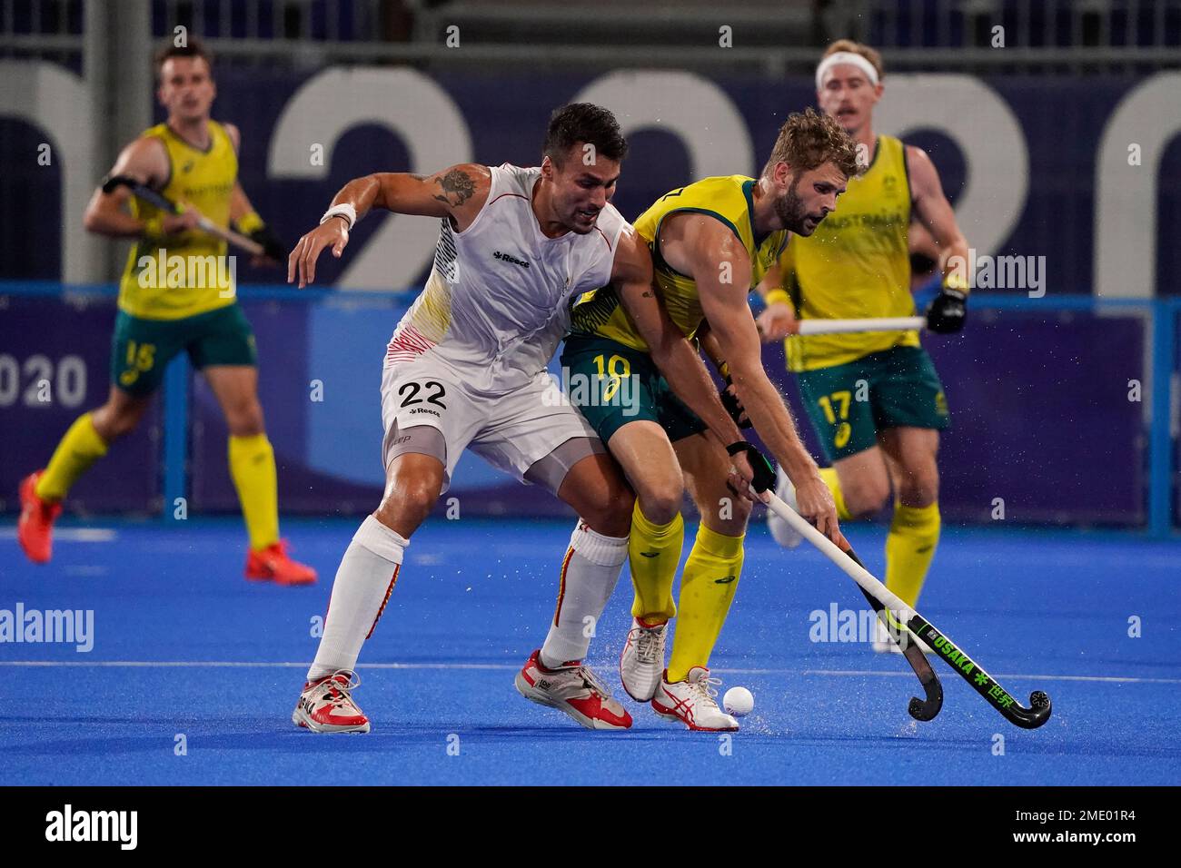 Belgium's Simon Pierre F Gougnard (22) and Australia's Joshua Beltz (10) battle for control of the ball during the men's gold medal field hockey match at the 2020 Summer Olympics, Thursday, Aug. 5, 2021, in Tokyo, Japan. (AP Photo/John Minchillo) Stockfoto