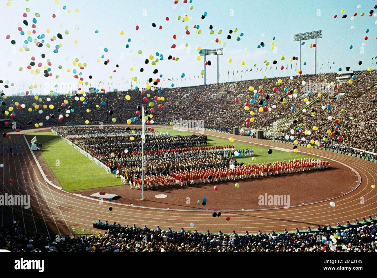 FILE In this Oct. 10, 1964, file photo, balloons fly over Olympians