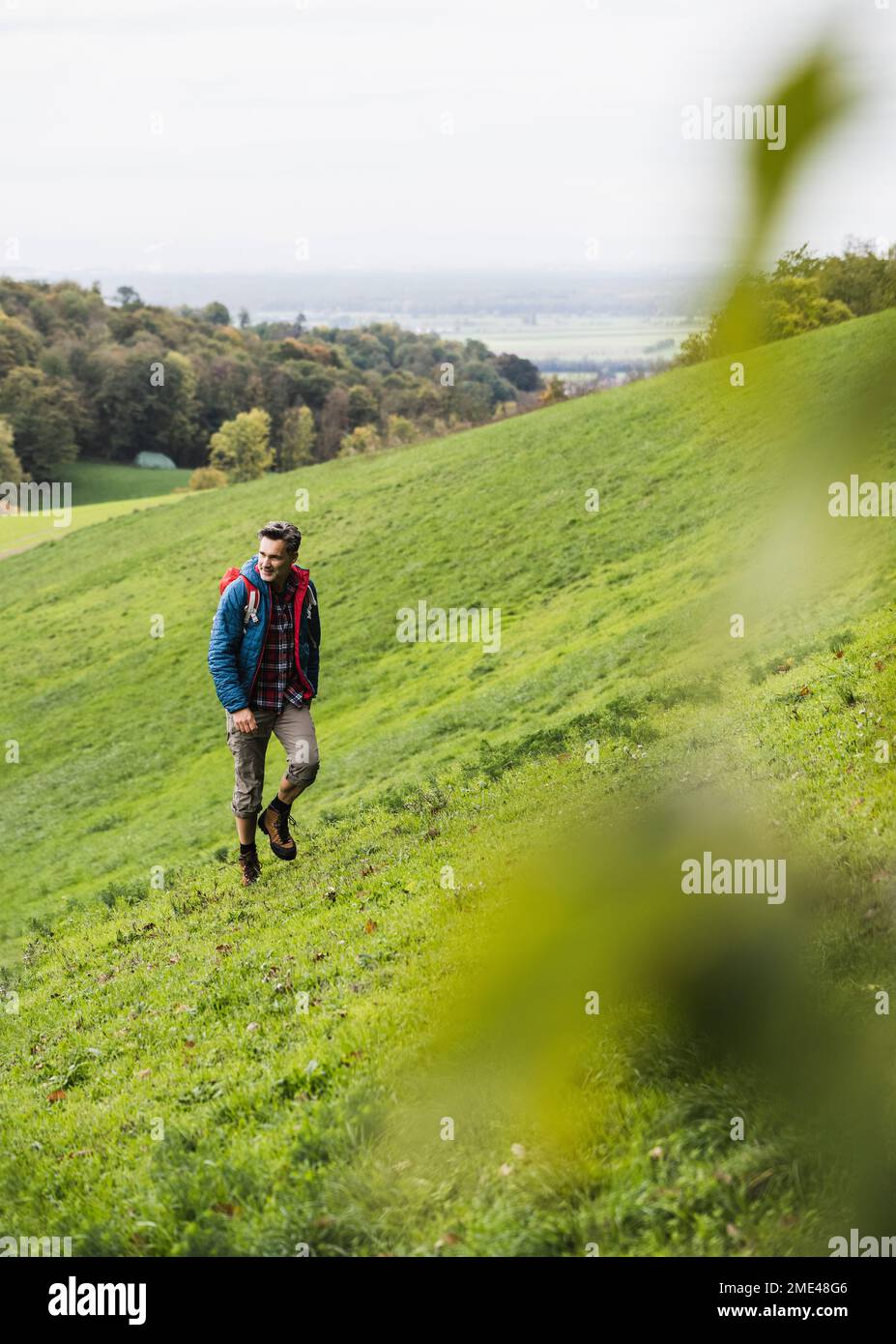 Reifer Mann, der im Urlaub auf der Wiese wandert Stockfoto