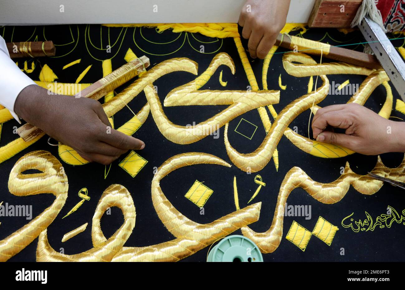 Saudi workers embroider Islamic calligraphy, using either pure silver