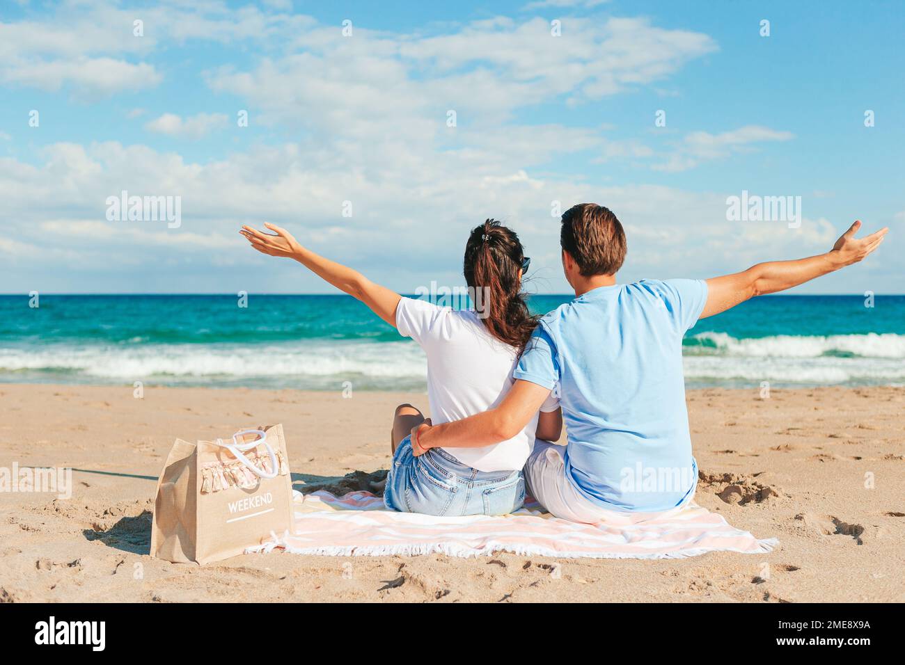 Ein junges Paar, das sich in den Sommerurlaub am Strand verliebt hat. Glücklicher Mann und glückliche Frau genießen die Zeit zusammen Stockfoto