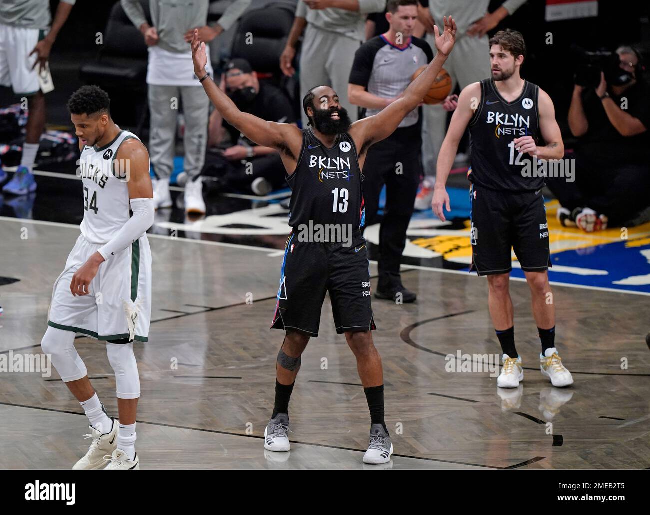 Brooklyn Nets guard James Harden (13) encourages the crowd to get behind  the team during the final minutes of Game 5 of a second-round NBA basketball  playoff series against the Milwaukee Bucks,