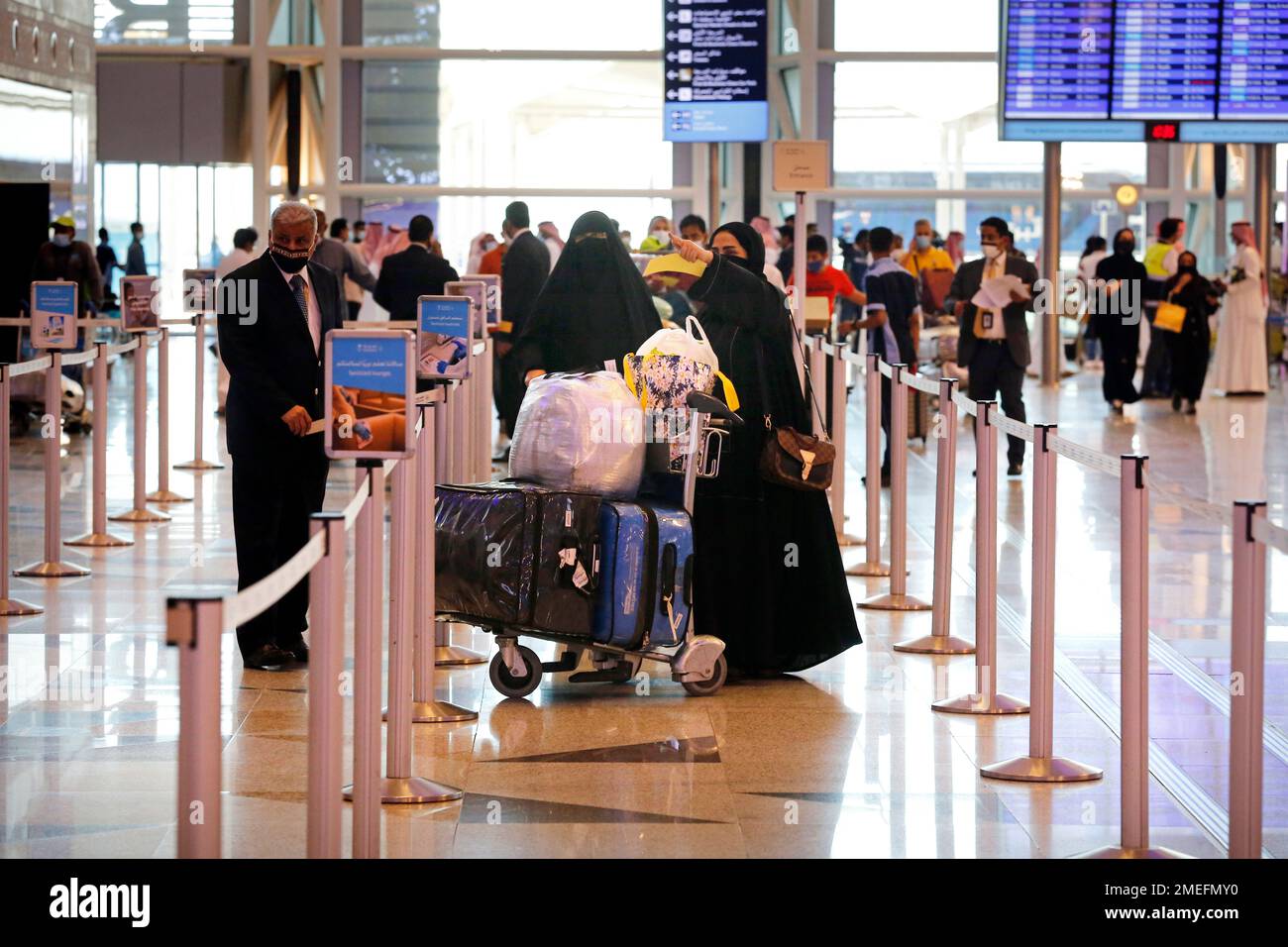 Saudi passengers enter King Abdulaziz International Airport in Jiddah