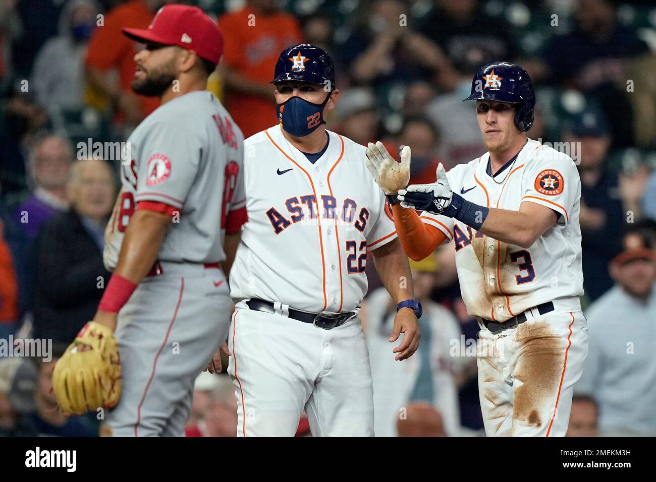 Houston Astros' Myles Straw (3) celebrates after hitting an RBI triple as Los Angeles Angels third baseman Jose Rojas, left, looks away during the second inning of a baseball game Thursday, April 22, 2021, in Houston. (AP Photo/David J. Phillip) Stockfoto