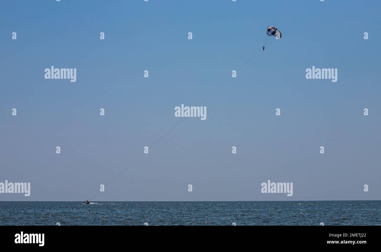 Parasailing ist eine beliebte Art von Outdoor-Aktivitäten am Meer. Der Fallschirm schwingt mit Touristen in den Himmel über dem Meer. Stockfoto