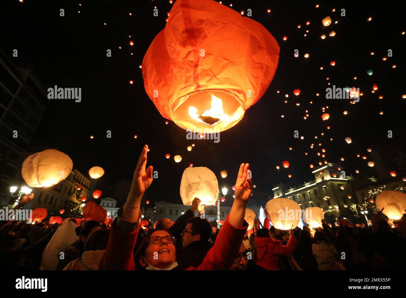 Während der Weihnachtsfeier „Night of Wishes“ vor dem Rathaus in Athen leuchten die Menschen Himmelslaternen. Stockfoto