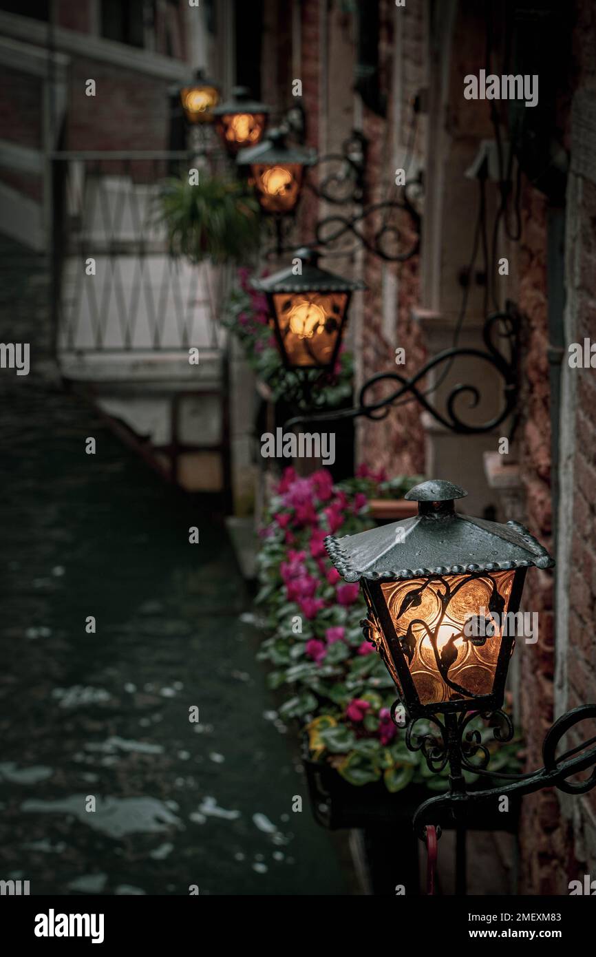 Eine Reihe von Straßenlaternen über einem Kanal in Venedig, Italien Stockfoto