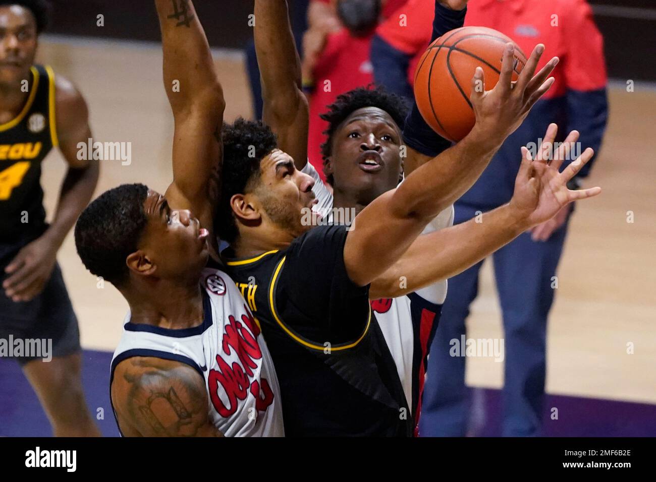 Missouri guard Mark Smith (13) attempts a layup between Mississippi guards Luis Rodriguez, left, and Jarkel Joiner during the first half of an NCAA college basketball game in Oxford, Miss., Wednesday, Feb. 10, 2021. (AP Photo/Rogelio V. Solis) Stockfoto
