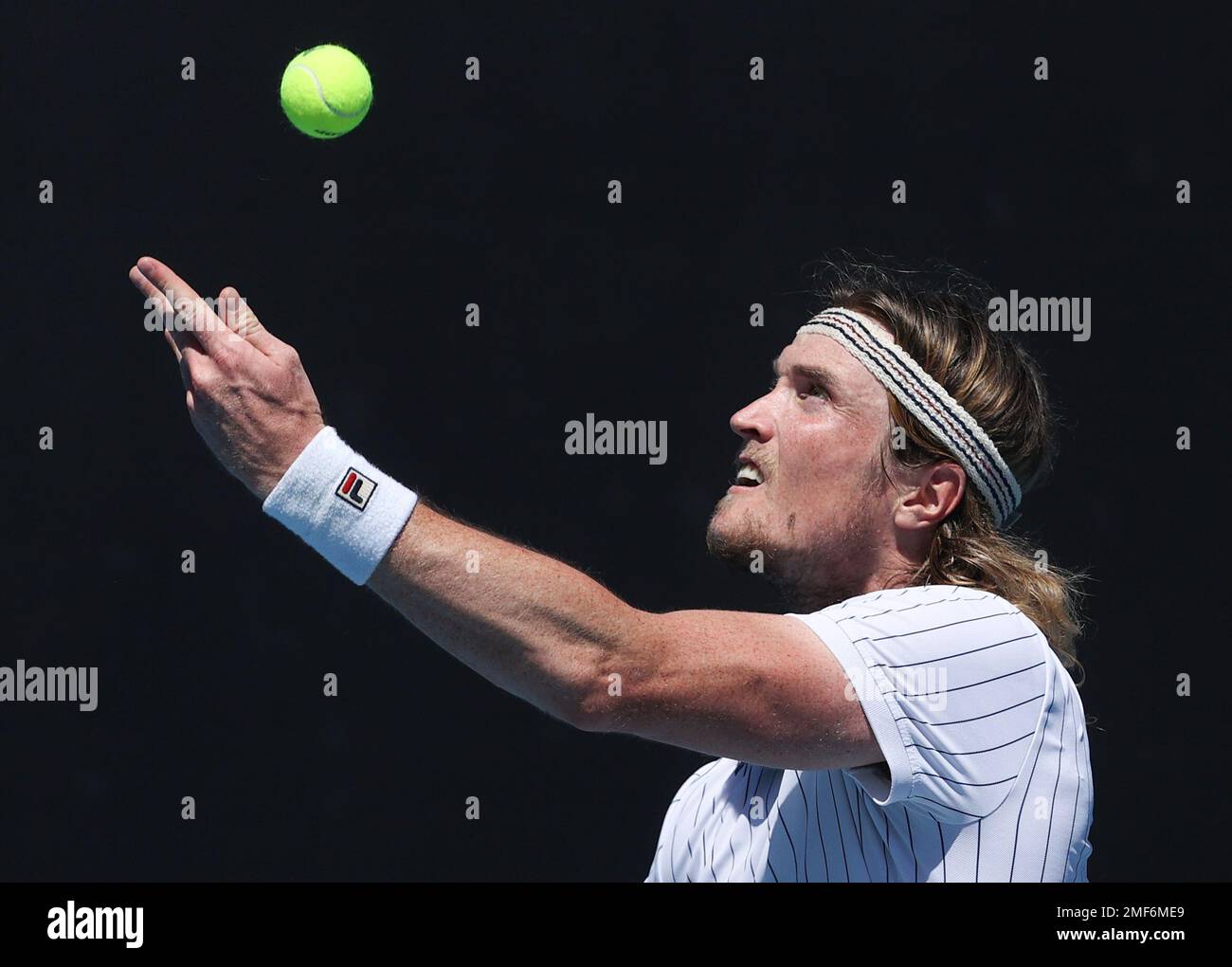 Denmark's Mikael Torpegaard serves to South Africa's Lloyd Harris during their first round match at the Australian Open tennis championship in Melbourne, Australia, Tuesday, Feb. 9, 2021.(AP Photo/Hamish Blair) Stockfoto