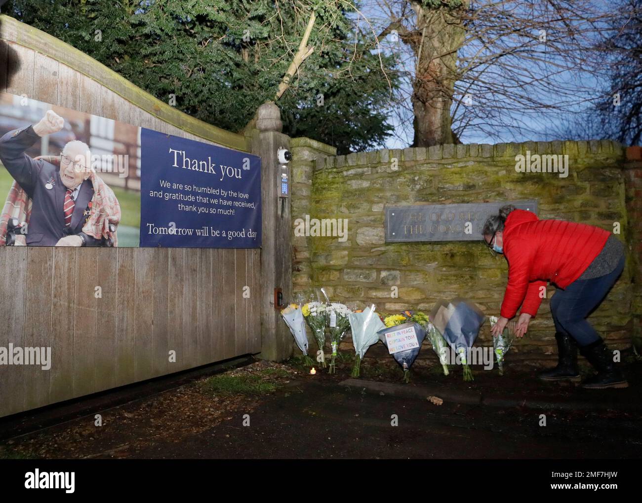 Flowers are placed near the home of Captain Tom Moore in Marston