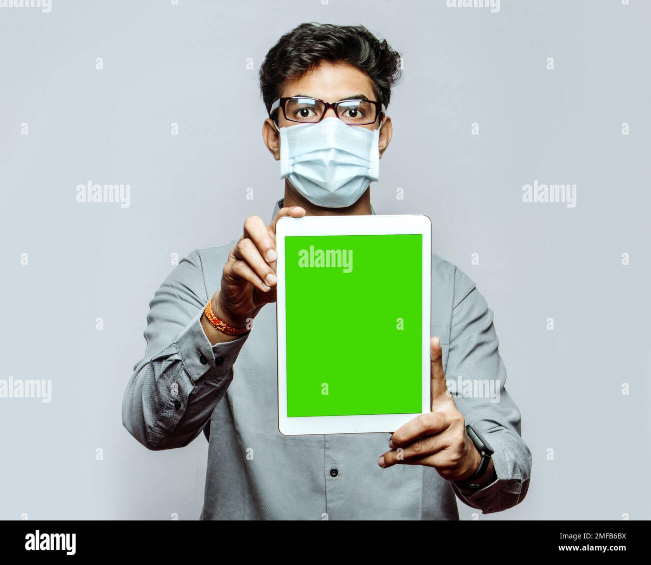 Männlicher medizinischer Fachmann, der ein mobiles oder Tablet-Marketingprodukt hält und Werbung und Werbeangebote anzeigt, um die Patientenbindung zu verbessern Stockfoto