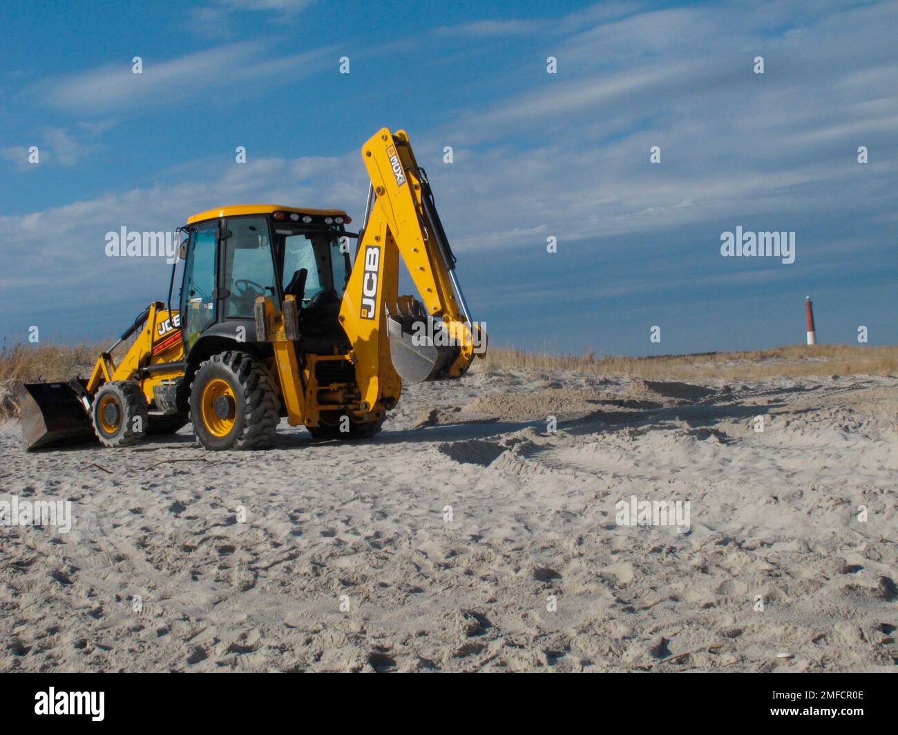 A frontend loader rests on the sand in Barnegat Light N.J. on Monday