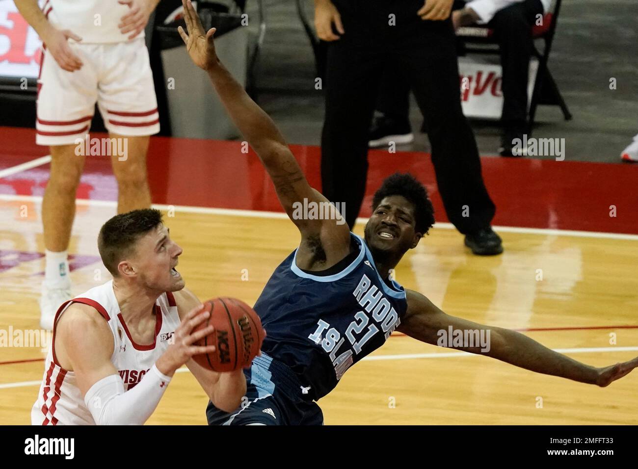 Wisconsin's Micah Potter shoots past Rhode Island's Makhi Mitchell
