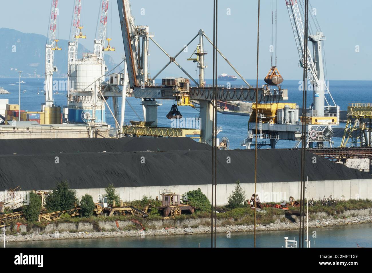 Blick auf Schwärzekrane, die im Hafen von Genua mit Portalkränen geladen und entladen werden. Stockfoto