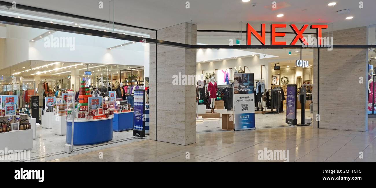 Next plc Einzelhandel Business Bekleidung Modegeschäft Schild und offener Eingang von einem Thurrock Essex Lakeside Shopping Centre Indoor Mall England UK Stockfoto