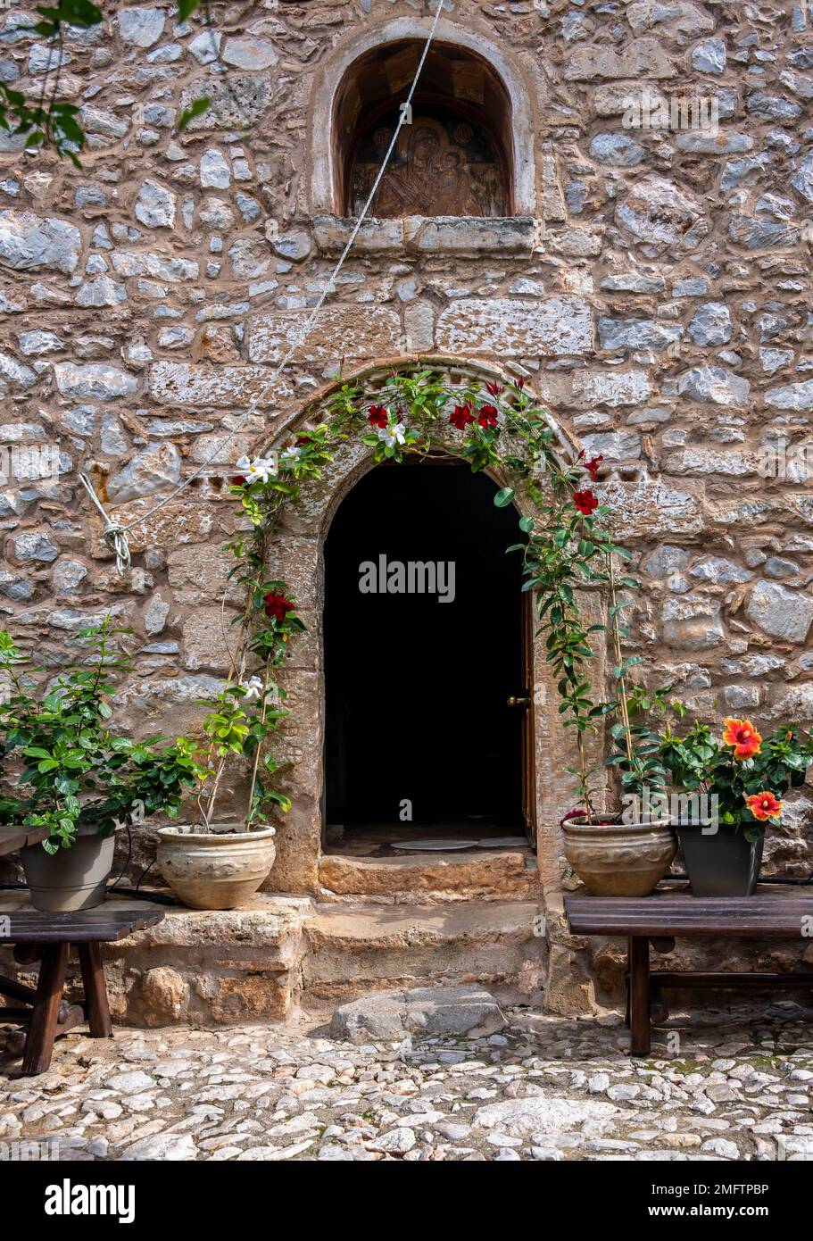 Eintritt mit Blumen, Steingebäude, Moni Agnountos Kloster, Peloponnes, Griechenland Stockfoto