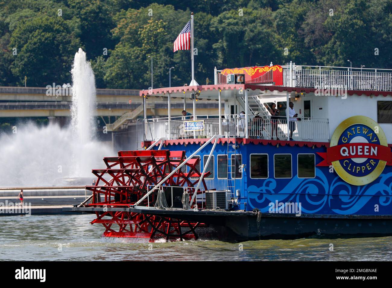 Three Rivers Queen Patrons watch from the stern of the 3 Rivers Queen as it passes by the ...