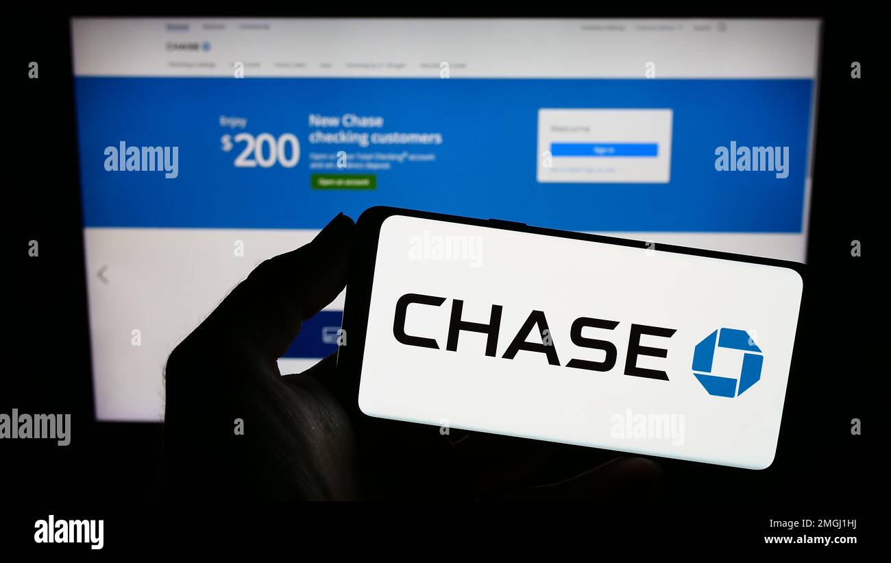 Person, die ein Smartphone mit dem Logo des US-Finanzunternehmens JPMorgan Chase Bank N.A. auf dem Bildschirm vor der Website hält. Konzentrieren Sie sich auf das Display des Telefons. Stockfoto