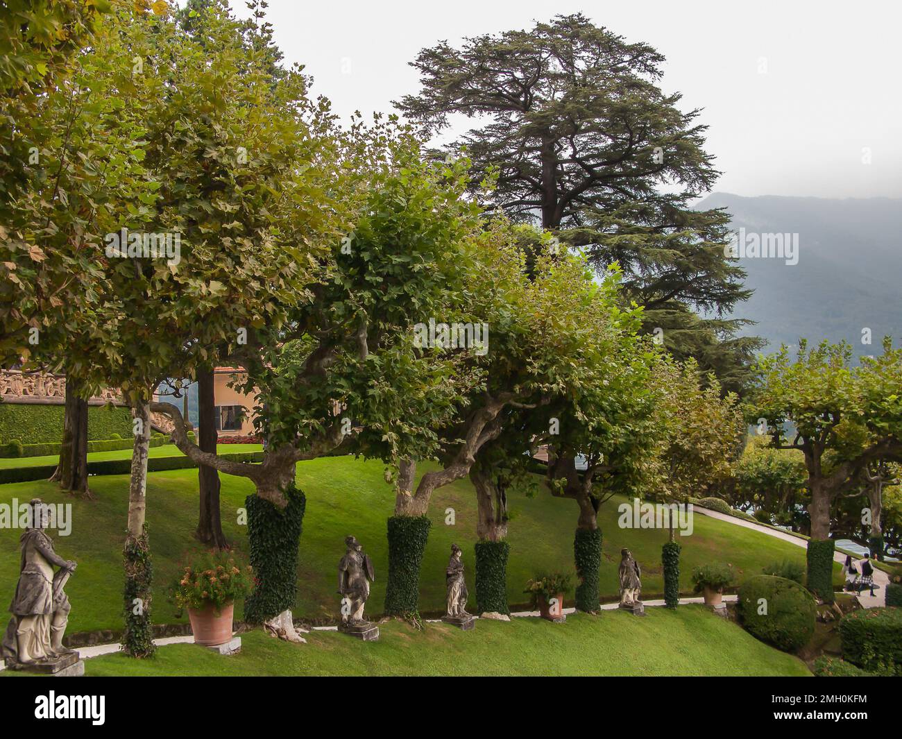 Wunderschöne Aussicht, grüne Rasenflächen, Bäume, Büsche und Skulpturen der Villa Balbianello, Lenno, des Сomo-Sees, Tremezzina, Italien Stockfoto