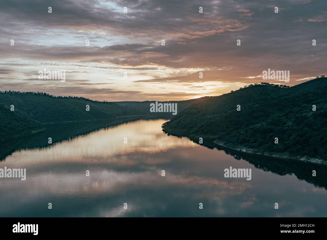 Fluss bei Sonnenuntergang mit Reflexionen des Himmels im Naturpark Monfrague in Caceres in Spanien Stockfoto