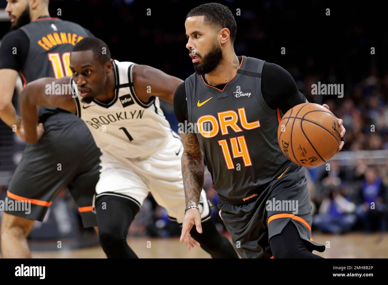 Orlando Magic guard D.J. Augustin (14) drives around Brooklyn Nets guard Theo Pinson (1) during the first half of an NBA basketball game, Monday, Jan. 6, 2020, in Orlando, Fla. (AP Photo/John Raoux) Stockfoto