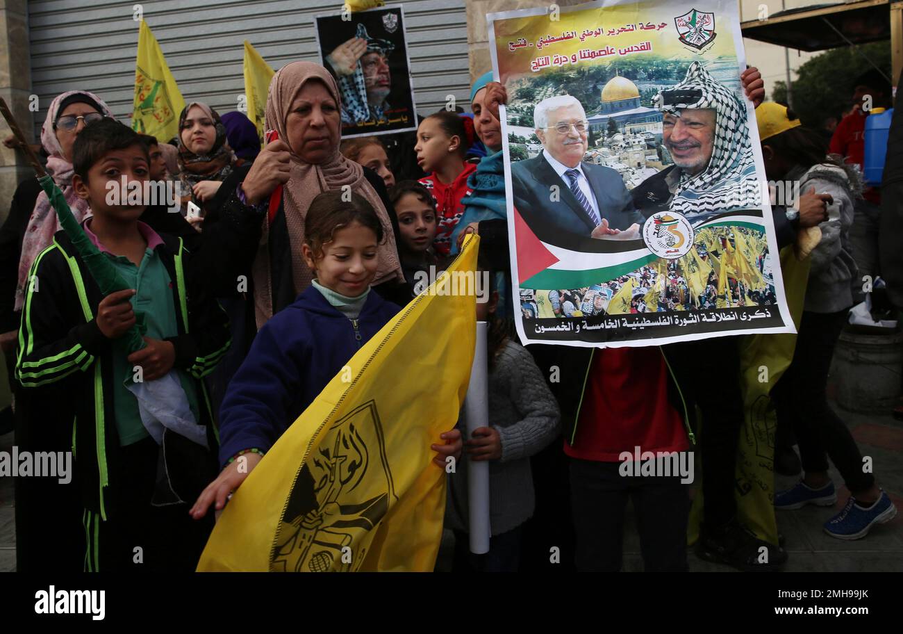 Palestinian Fatah supporters hold portraits of Palestinian President ...