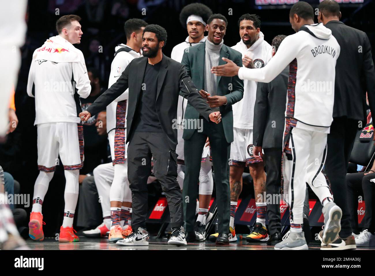 Injured Brooklyn Nets guard Kyrie Irving, center left, who has a right