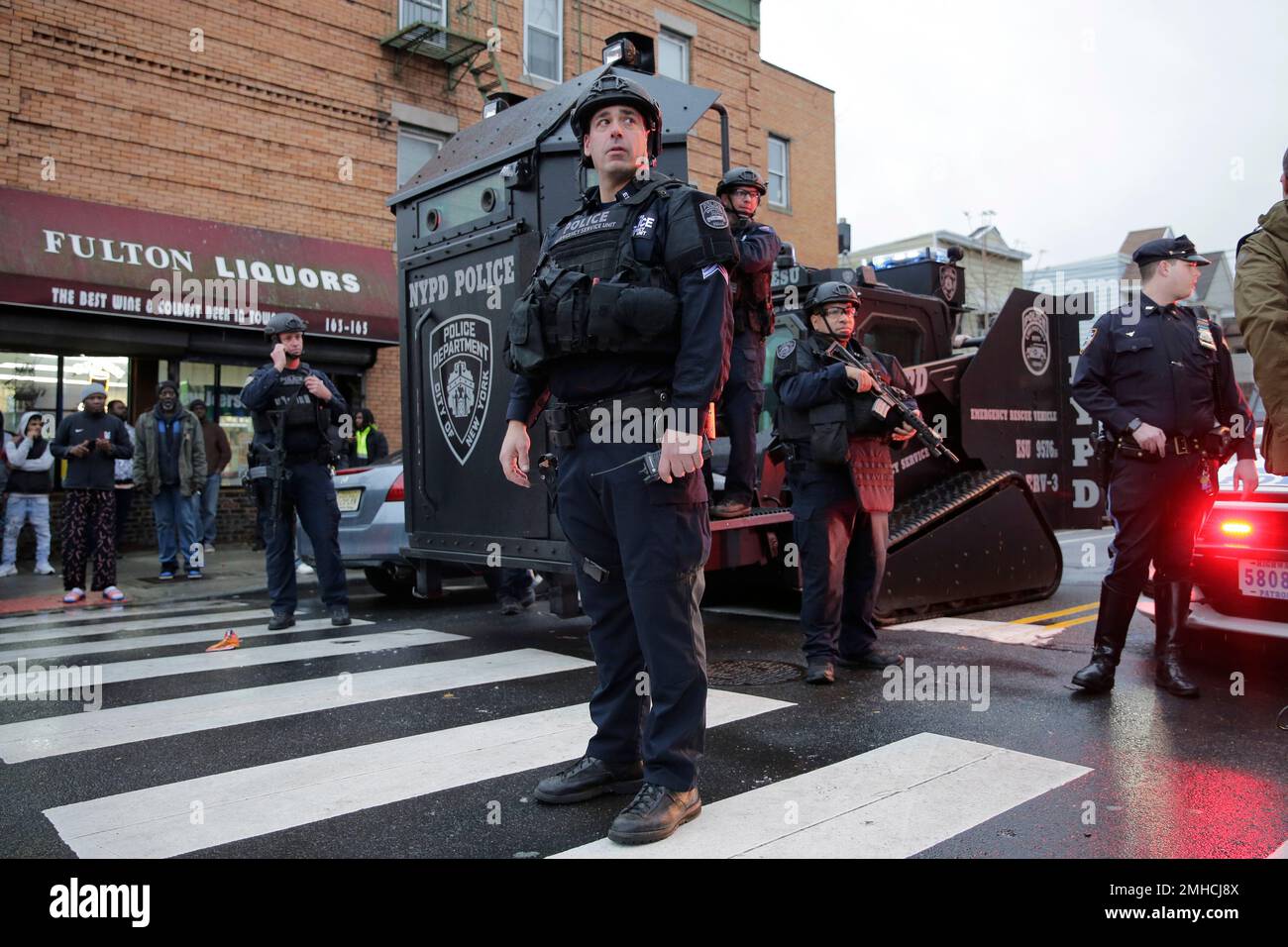 Emergency responders move heavy equipment near the scene of a shooting