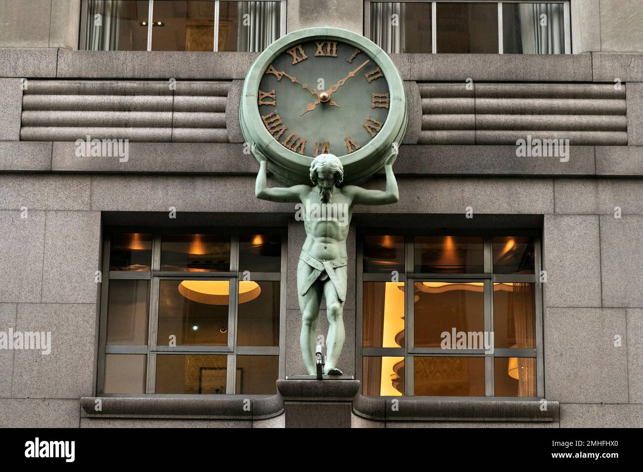 A sculpture of Atlas shoulders a clock on the facade of Tiffany's ...