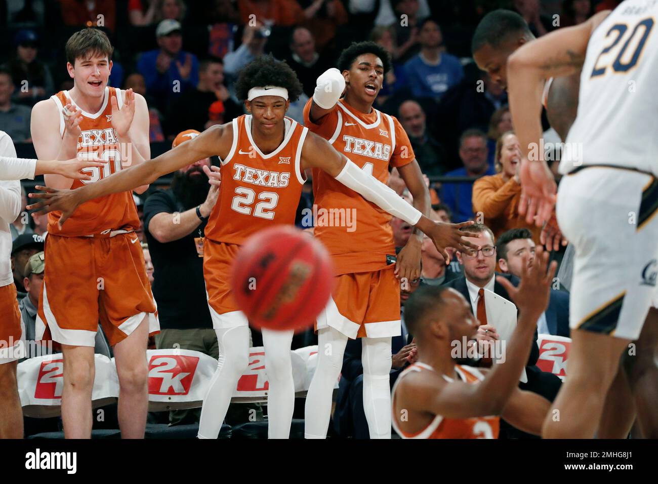 Texas center Will Baker (50), forward Kai Jones (22), and guard Donovan Williams (4) after Texas guard Matt Coleman III (2) got a difficult shot off during the second half of an NCAA college basketball game in the 2K Empire Classic, Thursday, Nov. 21, 2019, in New York. (AP Photo/Kathy Willens) Stockfoto