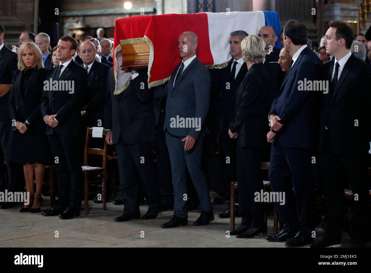 Pallbearers carry the coffin of late French President Jacques Chirac as French President Emmanuel Macron, second left, and his wife Brigitte, left, stand at Saint Sulpice church, Monday, Sept. 30, 2019 in Paris. Past and current heads of states are gathering in Paris to pay tribute to former French President Jacques Chirac who died last week at the age of 86. (AP Photo/Francois Mori, Pool) Stockfoto